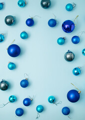 Blue Christmas decoration pattern with three shades of blue. Flatlay view on pastel background.