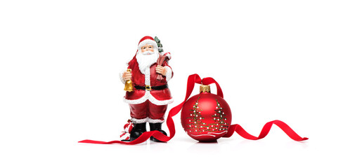 Christmas red ball with ribbon and Santa Claus with gifts on a white background. Merry christmas and happy new year greeting card