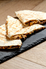 Quesadilla on a wooden table close-up shot