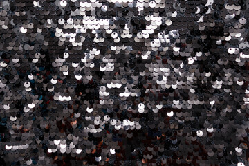 Shiny black sequins on fabric. Abstract shiny background, fashionable fabrics, blex, sequins....