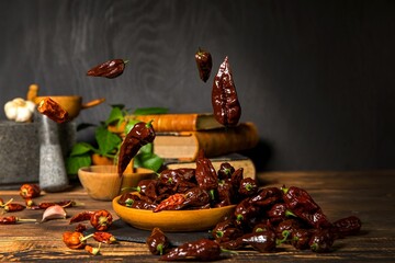 Chili pepper on wooden background.Extra hot chili. Naga Bhut Jolokia Chocolate. Exotic spices. Hot ingredients for food.