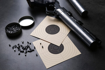Composition with sport pistol on black table. Professional gun