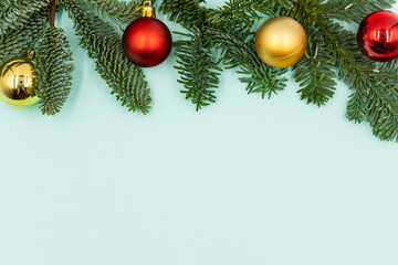 New Year's background. Christmas decorations and fir branches on a blue background. Top view.