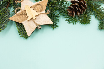 New Year's background. Christmas decorations and fir branches on a blue background. Top view.