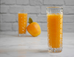 juice in a glass of orange apple on a light background
