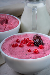 Close up of semolina pudding mousse with berries close up, vertical photo, selective focus.