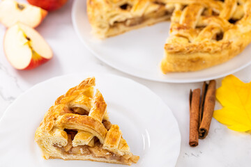 slice of apple pie and apple pie with apples and cinnamon