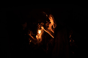 bonfire flames at night, dark background
