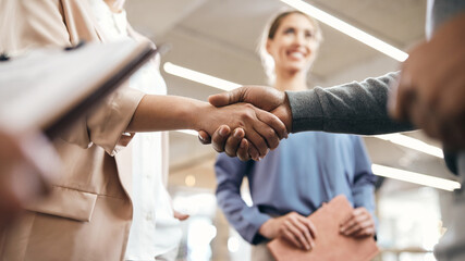 Close-up of business partners handshaking after successful agreement in office. - obrazy, fototapety, plakaty