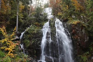  The beautiful 32m high Grande Cascade de Tendon, in autumn. The three-tiered waterfall is a scenic tourist attraction in the Haut Vosges area of eastern France. © Imladris
