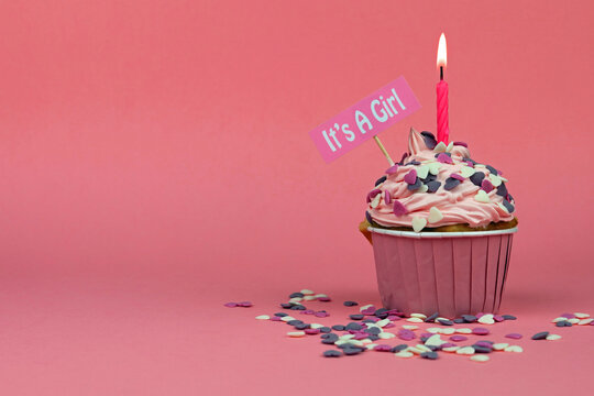 Pink Cupcake With Candle And The Message Its A Girl On A Pink Background