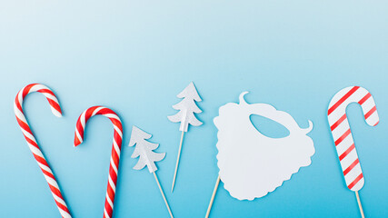 Group of cute paper Christmas party attributes on light blue template banner. Copy space.