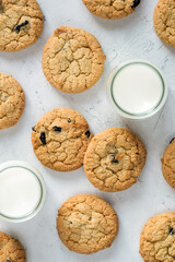 Cookies with chocolate and milk in a glass in the form of a pattern on a light table. An idea for a children's breakfast or snack. Design element. Flat lay, top view.