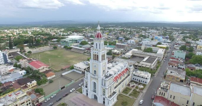 Aerial traveling out view of Sacred Heart of Jesus Church, Moca City, Espaillat Province, Dominican Republic. Toma a&eacute;rea Parroquia Sagrado Coraz&oacute;n De Jes&uacute;s Ciudad de Moca Provincia Esp&aacute;illat 