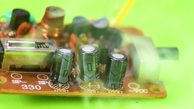 Damaged electrolytic capacitor on the printed circuit board.