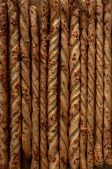 Italian bread sticks. Grissini with cheese and spices. Dry loaf. A traditional dish of the Piedmont province. Thanksgiving Day. How to replace bread. Flour dish. Party snacks.
