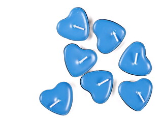 Group tea light candles in shape heart aluminum candle holders isolated on white background, top...