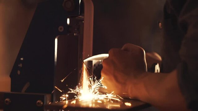 Man sharpening knife with sparks