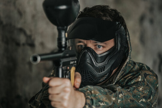 Portrait of paintball player, game in which participants simulate military combat using air guns to shoot capsules of paint at each other, sport concept