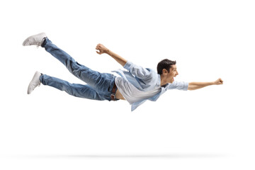 Casual young man in jeans flying