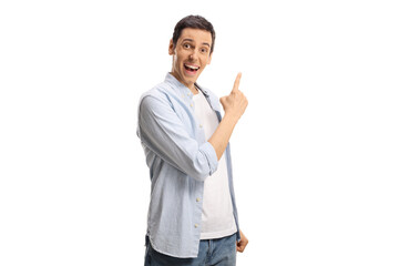Happy young man pointing with finger