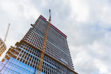 construction of skyscraper tower crane lifting of concrete plinths