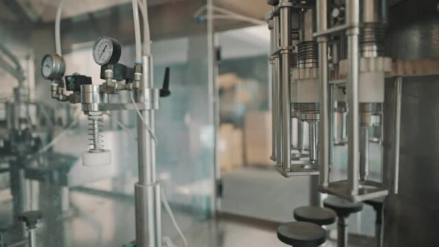 Automatic monoblock wine filling machine at wine factory.