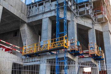 construction of a skyscraper fasade construction lift concrete and glass