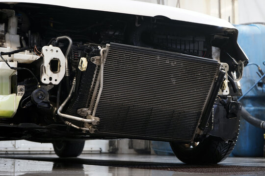 A radiator for cooling an engine of a modern car cleared of dirt. The cleaned radiator ensures efficient engine cooling.