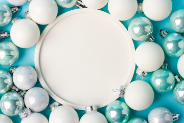 Decorative balls and plate with empty space for Christmas and New Year on a blue background