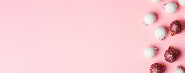 Christmas and New Year composition with Christmas tree decorations on a pink background