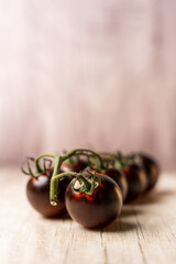 black tomatoes on a wooden table