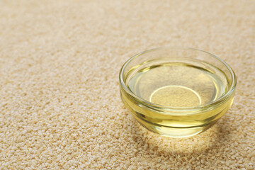 Bowl of fresh sesame oil on seeds. Space for text