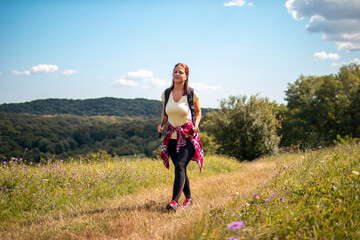 Beautiful woman hiking on pastures in the mountains