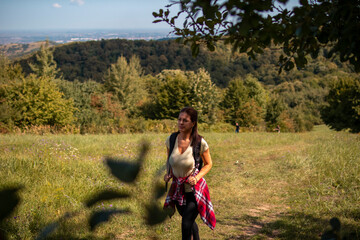 Beautiful woman hiking on pastures in the mountains