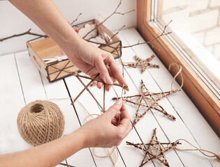 Fototapeta na wymiar Christmas stars from branches and jute rope, Make stars with your own hands. Master Class.