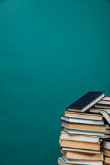stacks of books in the university library on a green background
