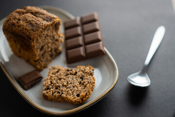 food photography: a small piece of cake on a stylish plate with a piece of chocolate