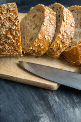 sliced pieces of bread on wooden board on gray background