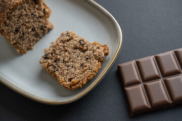 food photography: a small piece of cake on a stylish plate with a piece of chocolate