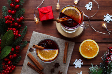 Two glasses of mulled wine on a festive table decorated for Christmas. Christmas hot drinks, winter...