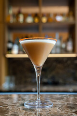delicious espresso martini with orange rim at a beautiful rustic bar