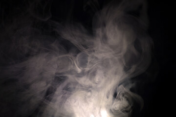 vague puffs of smoke on a black background