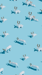 Christmas layout pattern with white reindeer toys isolated on pastel blue background. Creative New Year and holiday season concept. Minimal Xmas texture banner or greeting card. Flat lay, top view.