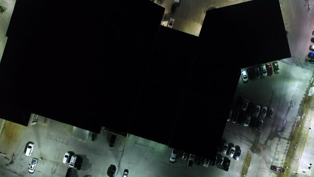 Top Down View Over Car Dealership At Night Moving Forward
