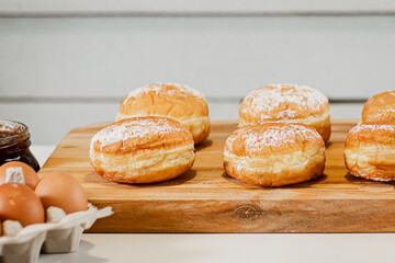 Cooking Hanukkah donuts or sufganiyot. Traditional sweets for Jewish holiday. Fresh berliner dessert at home kitchen.