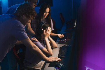 Female online player wearing headphones losing shooter competition