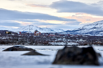 The village Abisko East in northern Sweden a dark afternoon just before the polar night occurs in...