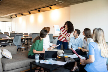 Businesswoman showing a document to her colleagues