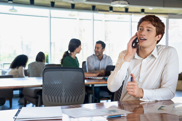 Portrait of young businessman talking on a smartphone